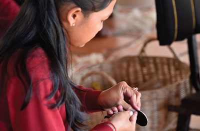 A skilled artisan at Senteurs d'Angkor meticulously crafting a product by hand, exemplifying traditional Cambodian craftsmanship and dedication to quality.