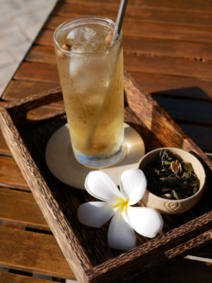 Iced tea in a glass with a stainless steel straw